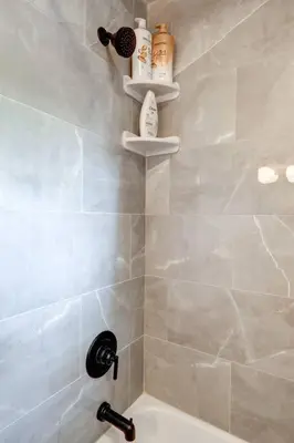 a bathroom with a shower with a sink and a tub at New cozy home near Outlets & Amish Country in Lancaster
