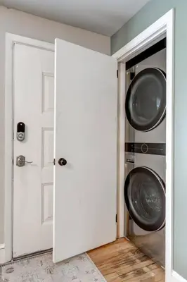 an open door to a laundry room with two washing machines at New cozy home near Outlets & Amish Country in Lancaster