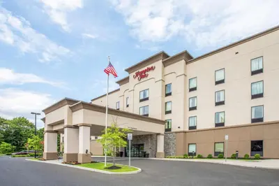 a hotel with an american flag in front of it at Hampton Inn Philadelphia/Voorhees in Voorhees