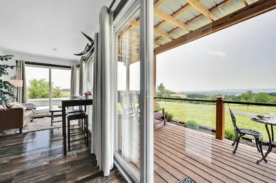 a view from the porch of a house with a balcony at Pine Grove Scenic View Unforgettable Love Getaway in Pine Grove