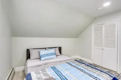 a white bedroom with a bed and a window at Jersey City Vacation Rental about 8 Mi to NYC! in Jersey City