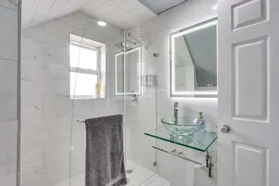 a bathroom with a glass sink and a shower at Jersey City Vacation Rental about 8 Mi to NYC! in Jersey City