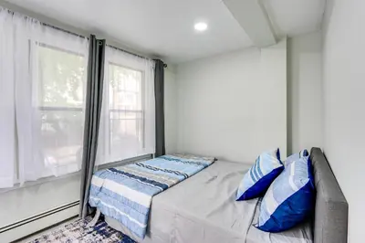 a small bedroom with a bed and a window at Jersey City Vacation Rental about 8 Mi to NYC! in Jersey City