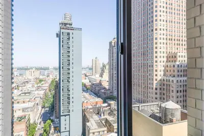 a view of a city with a tall building at Sq 1BR w Great views Indoor pool NYC-29 in New York
