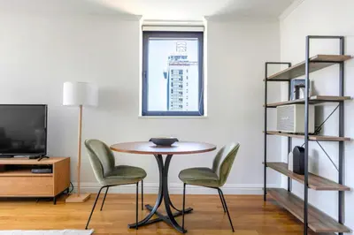 a table and chairs in a room with a window at Sq 1BR w Great views Indoor pool NYC-29 in New York