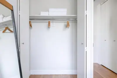 a closet with white walls and a mirror at Sq 1BR w Great views Indoor pool NYC-29 in New York