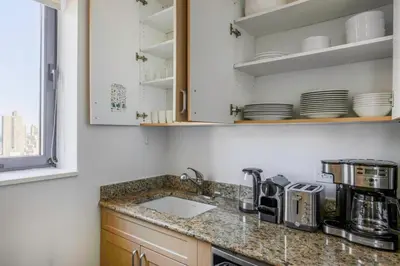 a kitchen with a sink and a counter top at Sq 1BR w Great views Indoor pool NYC-29 in New York