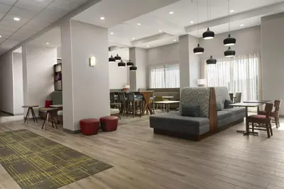 a lobby with a couch and tables and chairs at Hampton Inn & Suites Somerset in Somerset