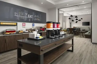 a restaurant with a counter with wine bottles on it at Hampton Inn & Suites Somerset in Somerset
