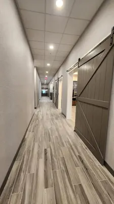 an empty hallway with a wooden floor and a barn door at Hampton Inn & Suites Somerset in Somerset