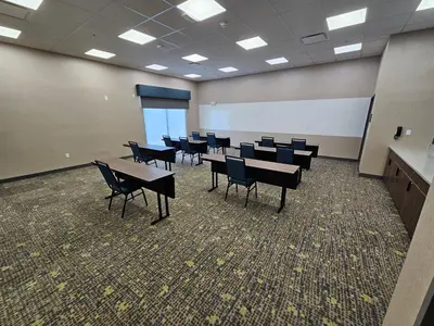 a classroom with tables and chairs and a whiteboard at Hampton Inn & Suites Somerset in Somerset