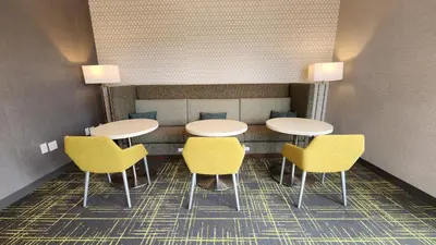 a dining room with two tables and yellow chairs at Hampton Inn & Suites Somerset in Somerset
