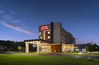a hotel with a sign on the side of a building at Hampton Inn & Suites Somerset in Somerset