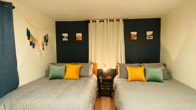 two beds sitting next to each other in a bedroom at Family retreat, Closest Rental House to POOL & BEACH, Hot tub, Game Room in Tobyhanna
