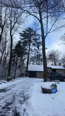 a snow covered yard with a tree and a house at Family retreat, Closest Rental House to POOL & BEACH, Hot tub, Game Room in Tobyhanna