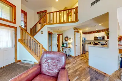 a living room with a couch and a staircase at Northridge 197 in Tannersville