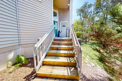 a wooden staircase leading to a house with a door at Northridge 197 in Tannersville