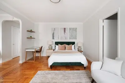 a white bedroom with a bed and a desk at 105 -5G Brand New Studio prime location Elevator in New York