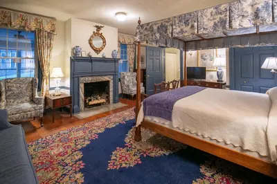 a bedroom with a bed and a fireplace at Cameron Estate Inn in Mount Joy