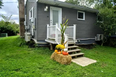 a house with a porch with pumpkins on the grass at Cameron Estate Inn in Mount Joy