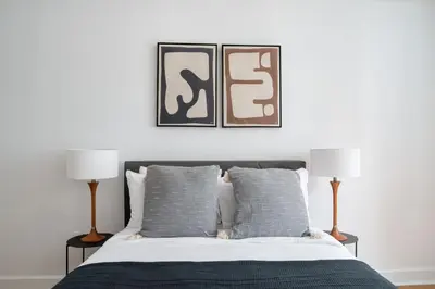 a bedroom with a bed with two lamps at Midtown East 2br w gym wd nr Grand Central NYC-1146 in New York