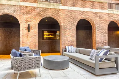 a patio with a couch and chairs and a table at Midtown East 2br w gym wd nr Grand Central NYC-1146 in New York