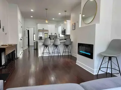 a living room with three stools and a fireplace at Secret Escape 20 Min from NYC N 1 in Jersey City