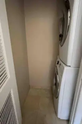 a small kitchen with a white refrigerator in a room at Liberty Dream - 20 min to NYC in Jersey City