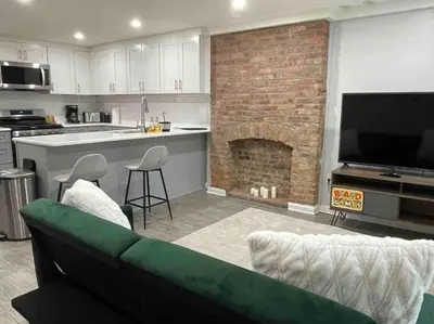 a living room with a couch and a fireplace at Sweet Home - 20 minutes to NYC in Jersey City