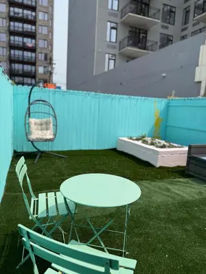 a table and two chairs and a table and a fence at Sweet Home - 20 minutes to NYC in Jersey City