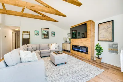 a living room with a couch and a tv at Deck and Community Perks Bright Pocono Lake Home! in Pocono Lake