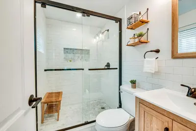 a bathroom with a shower and a toilet and a sink at Deck and Community Perks Bright Pocono Lake Home! in Pocono Lake