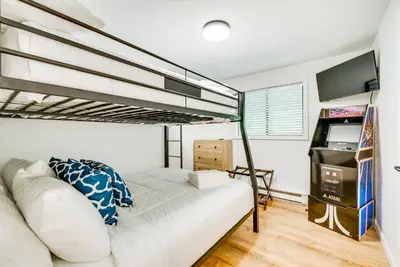 a bedroom with a bed and a bunk bed at Deck and Community Perks Bright Pocono Lake Home! in Pocono Lake