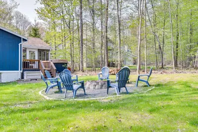 a group of chairs sitting around a table in a yard at Deck and Community Perks Bright Pocono Lake Home! in Pocono Lake