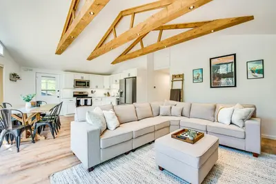 a living room with a couch and a table at Deck and Community Perks Bright Pocono Lake Home! in Pocono Lake