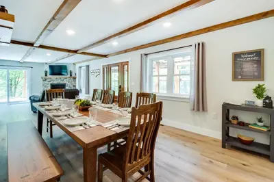 a dining room with a long table and chairs at Pickleball Court and Fire Pit Milton Cabin! in Milton