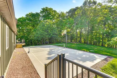 a basketball court in front of a house at Pickleball Court and Fire Pit Milton Cabin! in Milton