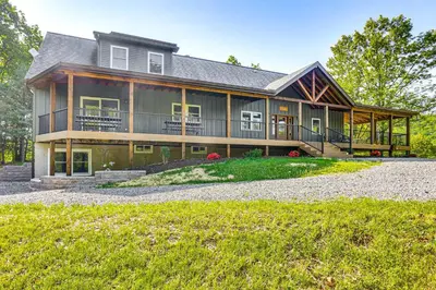 a large house with a gambrel roof at Pickleball Court and Fire Pit Milton Cabin! in Milton