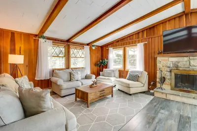 a living room filled with furniture and a fireplace at Swim Dock and Game Room Lakefront Poconos Cabin! in Long Pond