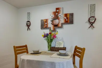 a dining room table with a vase of flowers on it at Quakertown Vacation Rental Close to Hiking Trails in Quakertown