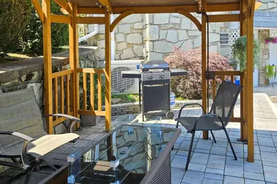 a patio with a grill and chairs and a table at Quakertown Vacation Rental Close to Hiking Trails in Quakertown
