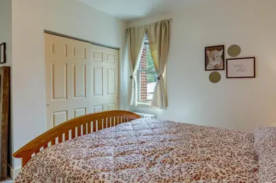 a bedroom with a bed and a window and a door at Walk to Restaurants and Shops Apt in Pennsylvania! in Pottstown