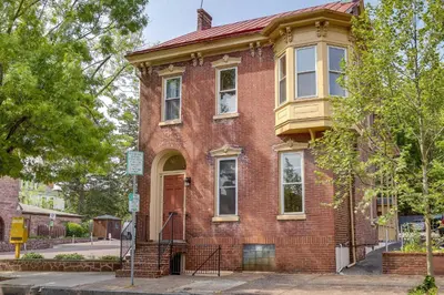 an old red brick house on a street at Walk to Restaurants and Shops Apt in Pennsylvania! in Pottstown