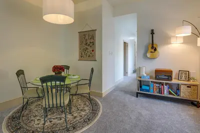 a dining room with a table and chairs and a guitar at Walk to Restaurants and Shops Apt in Pennsylvania! in Pottstown