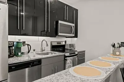 a kitchen with stainless steel appliances and a counter top at StayRafa At 261 4R in Philadelphia
