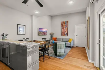 a kitchen and living room with a table and a couch at StayRafa At 261 4R in Philadelphia