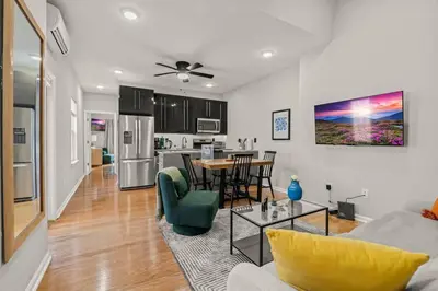 a living room with a couch and a table at StayRafa At 261 4R in Philadelphia