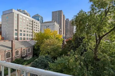 a view of a city with tall buildings and trees at StayRafa At 261 4R in Philadelphia