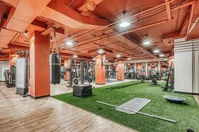 a gym with dumbbells and rackets on the floor at FiDi 1br w gym doorman wd nr Wall St NYC-983 in New York