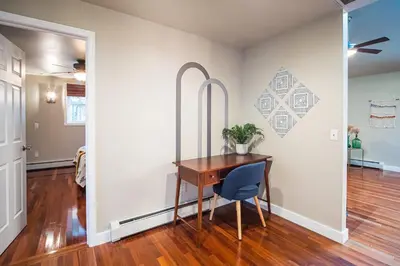 a dining room with a wooden table and a blue chair at 2 Houses, 22+Guests, 2 Hot Tubs, Renovated, Events Welcome! in Hawley